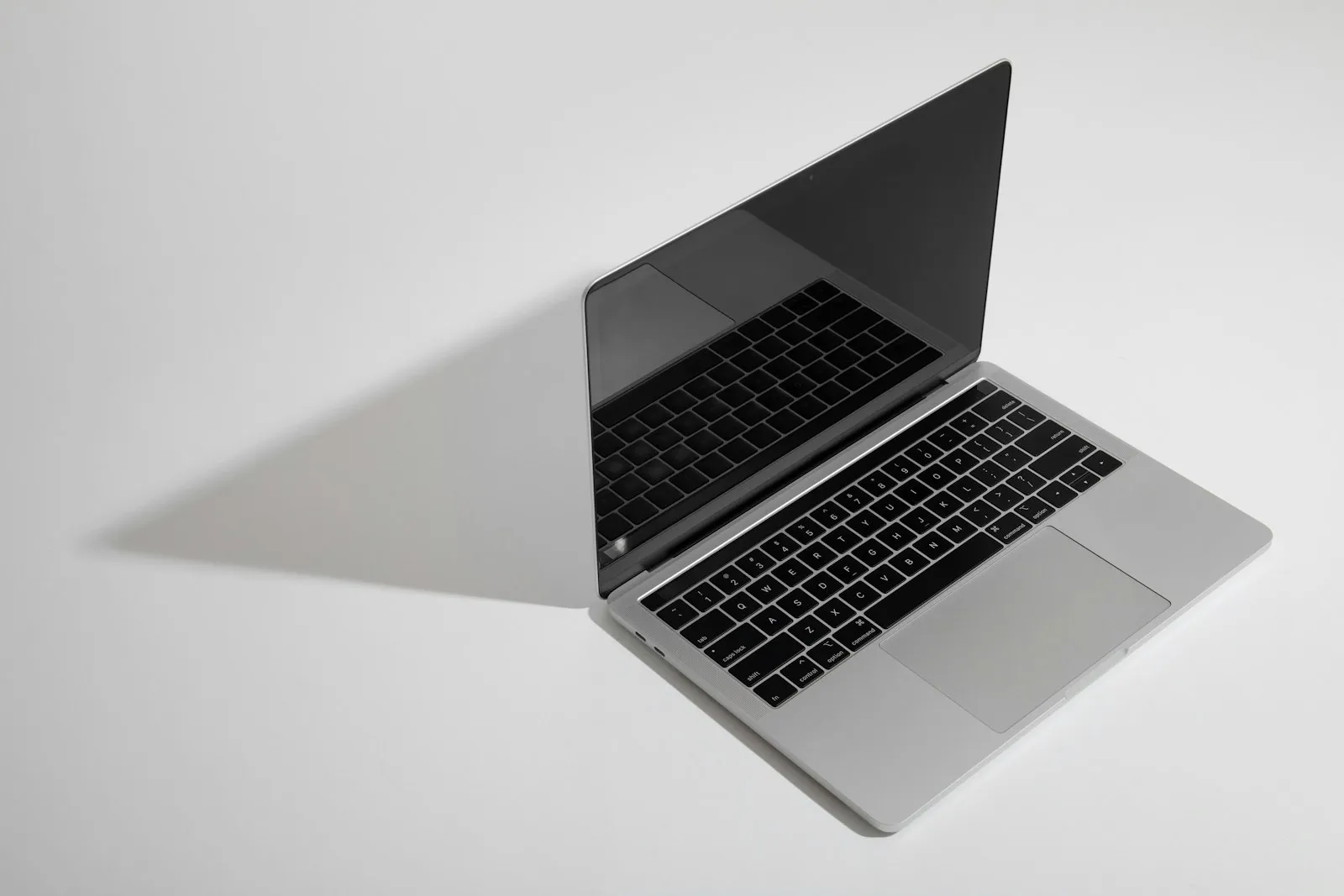 An open laptop casting a soft shadow
