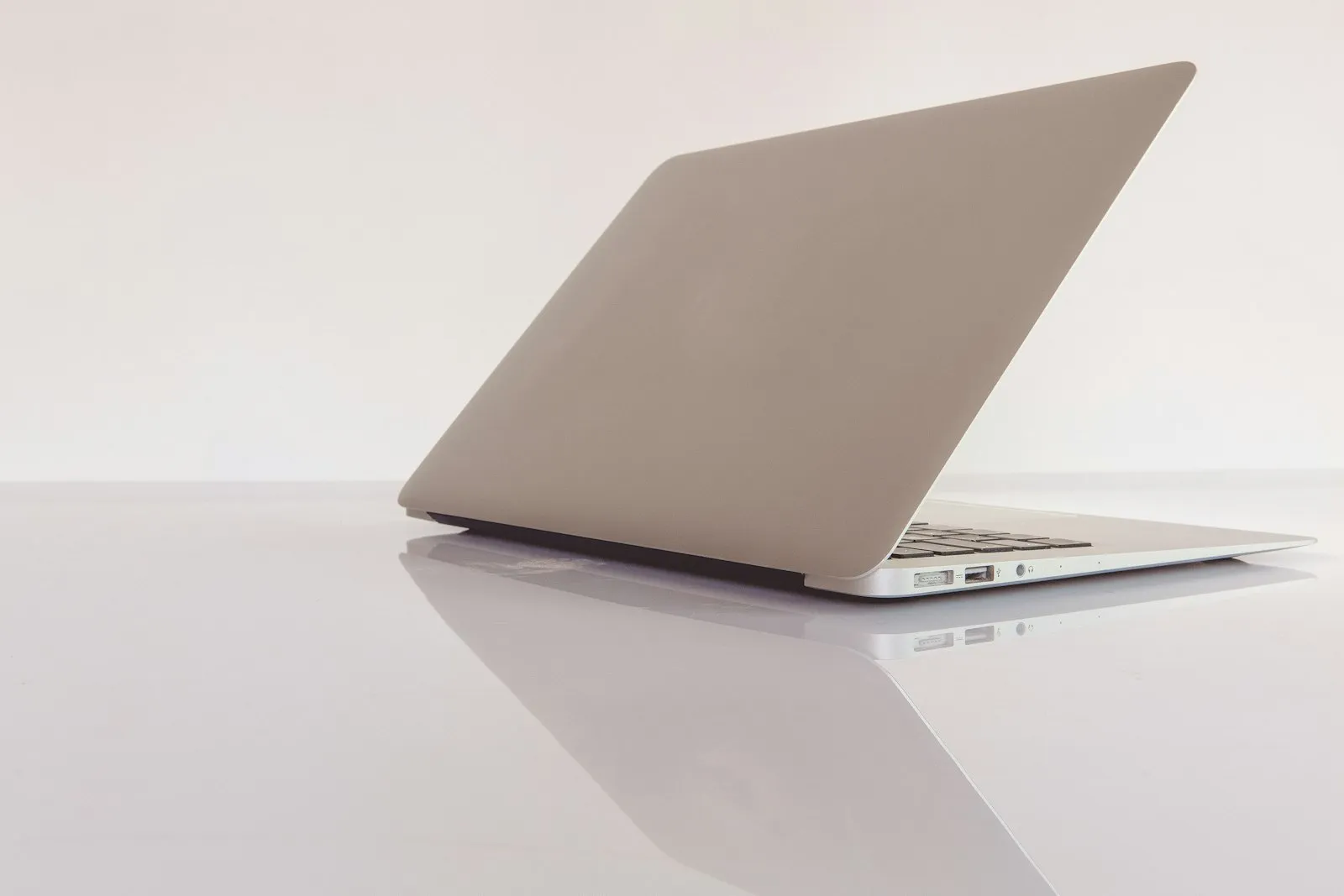 A silver laptop on a white surface