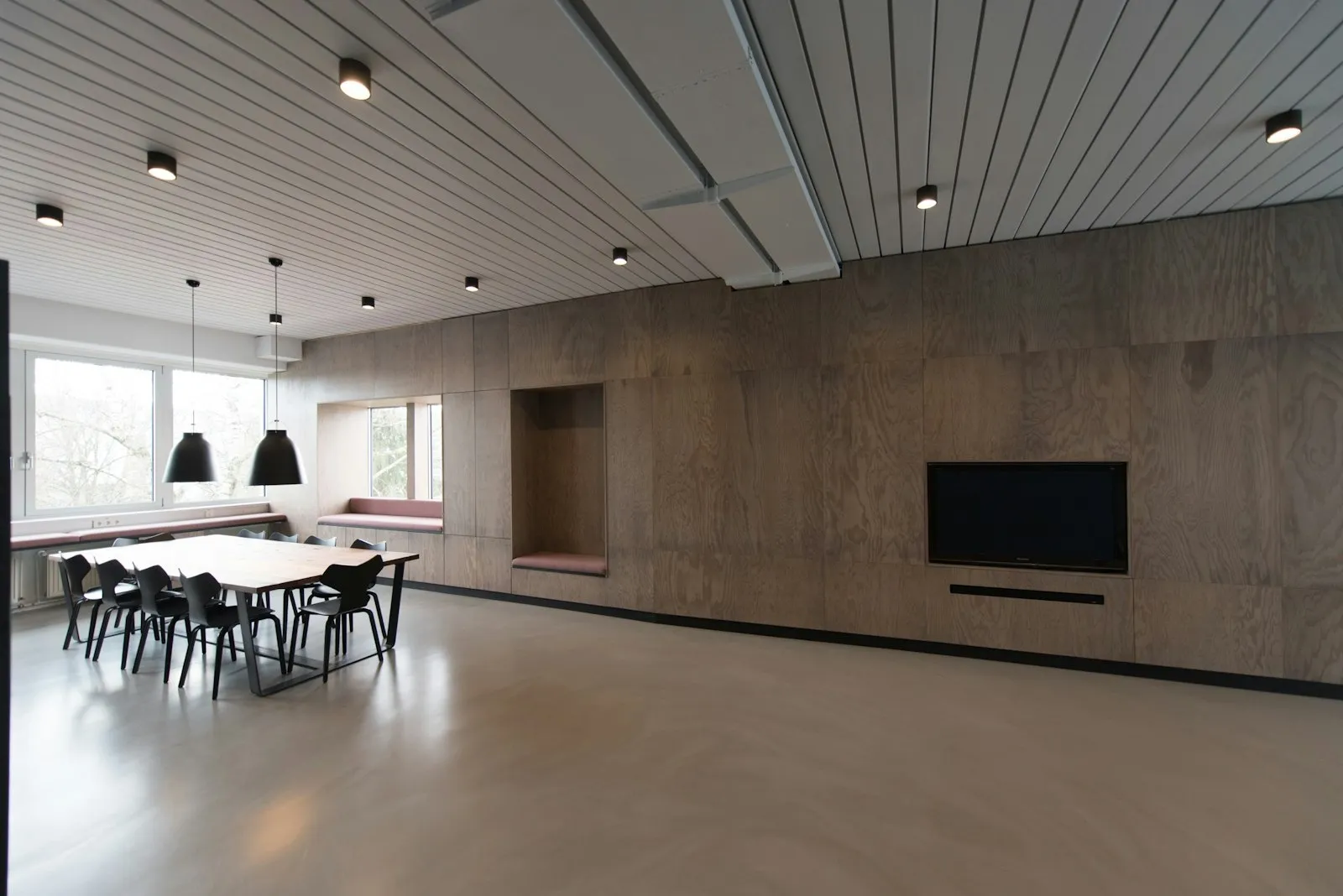 A bright, empty meeting room with a long table