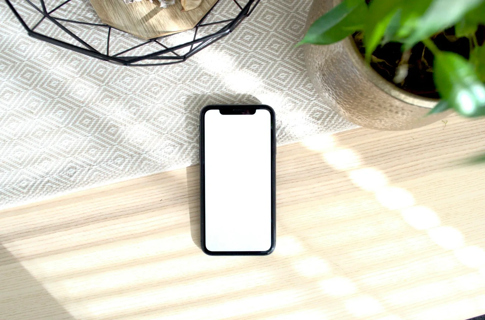 A smartphone lying in the sun on a table